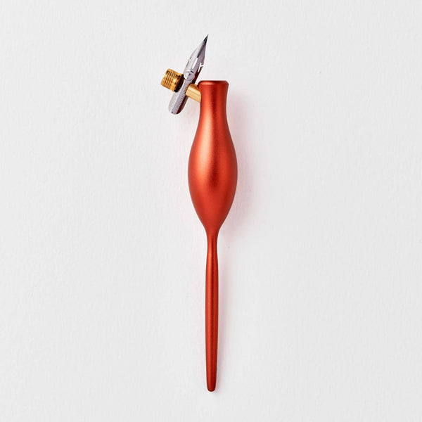 Red feather pen on a white background