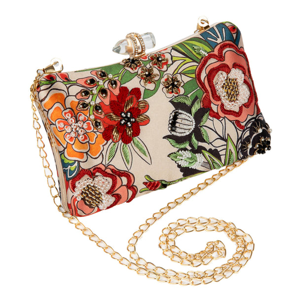 Floral patterned clutch bag with gold chain strap on a white background