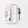 Purple pen with packaging on a white background