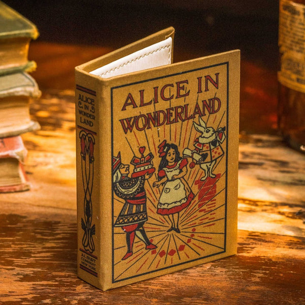 A book wallet designed to look like a miniature antique book with a cloth on hardcover, featuring illustrations of characters from 'Alice in Wonderland'.