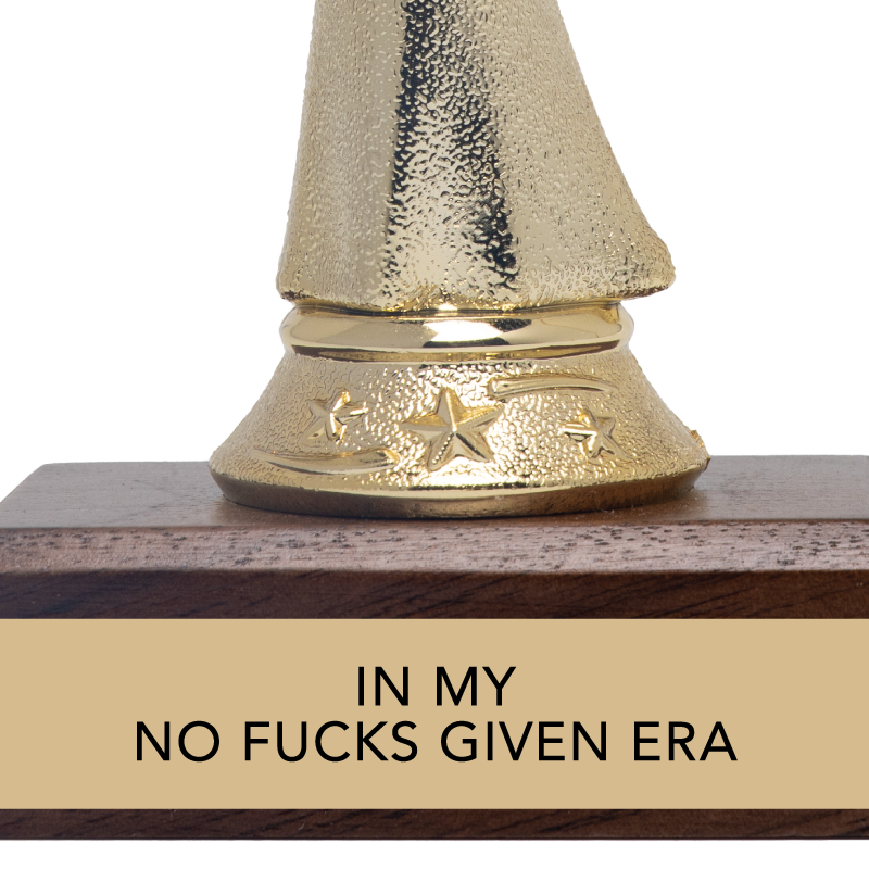 Gold trophy with wooden base and humorous text on a white background