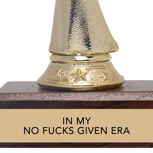 Gold trophy with wooden base and humorous text on a white background