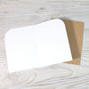 White card with brown envelope on a wooden surface