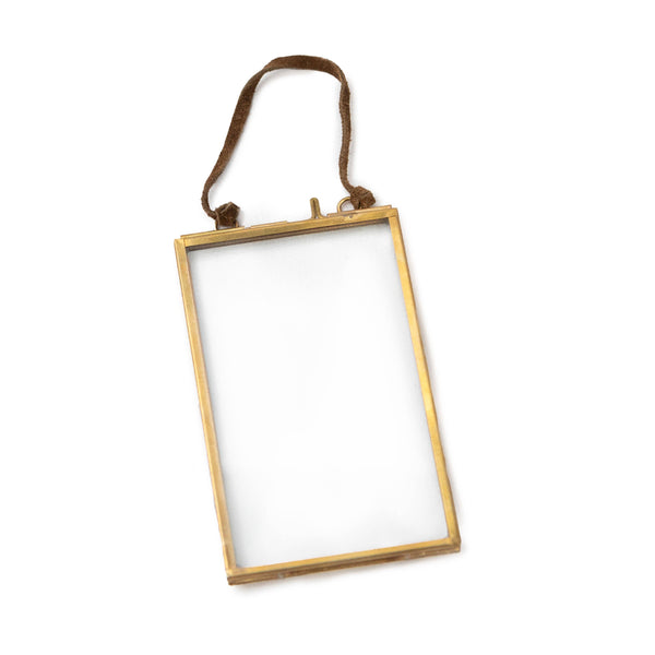 Gold picture frame with a brown strap on a white background