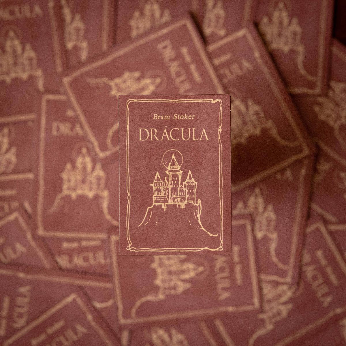 Stack of 'Dracula' books by Bram Stoker with decorative cover design.