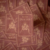 Stack of 'Dracula' books by Bram Stoker with decorative cover design.