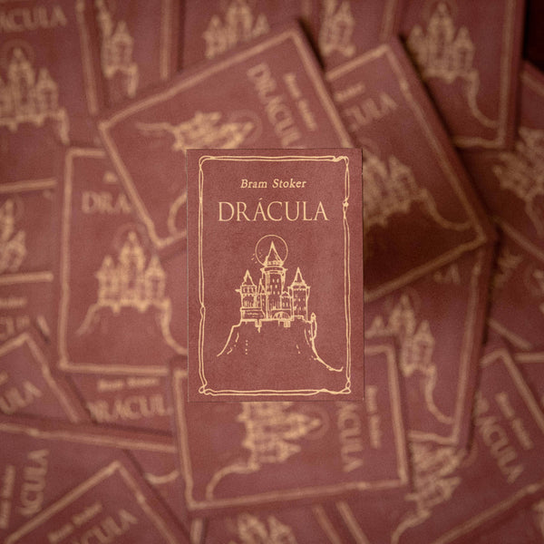 Stack of 'Dracula' books by Bram Stoker with decorative cover design.