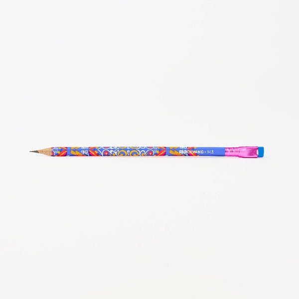 A colorful wooden pencil with a blue body, vibrant floral pattern, and a pink eraser, shown horizontally against a plain white background.