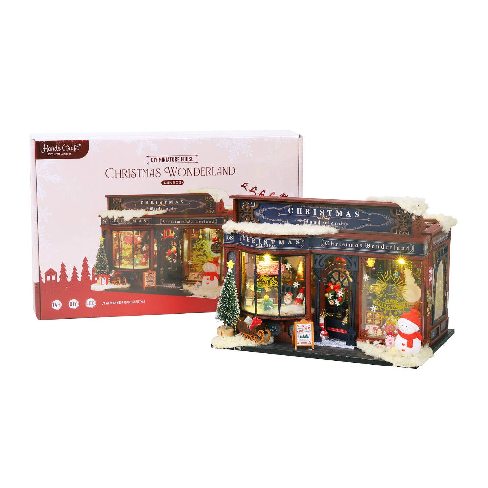 Christmas-themed miniature building with 'Christmas Wonderland' sign, next to its packaging.