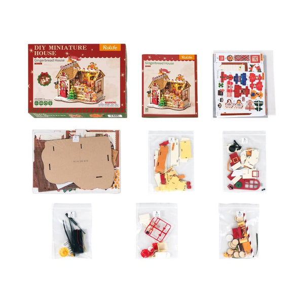 DIY miniature house kit packaging with components on a white background