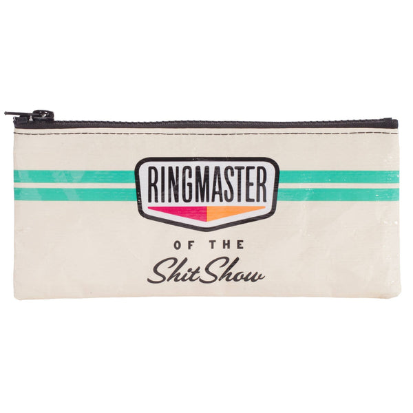 A cream-colored zippered pouch featuring a black zipper, a teal stripe, and a central graphic that reads 'RINGMASTER OF THE ShitShow' in stylized text.