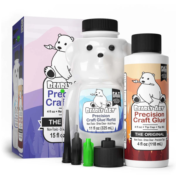 A product image featuring a bottle of Bearly Art Precision Craft Glue with a bear-themed design, alongside a smaller bottle of refill, a tip kit, and packaging box. The glue is white with a cartoon bear face, and the additional bottles and tips are shown in front of a blue and pink background.