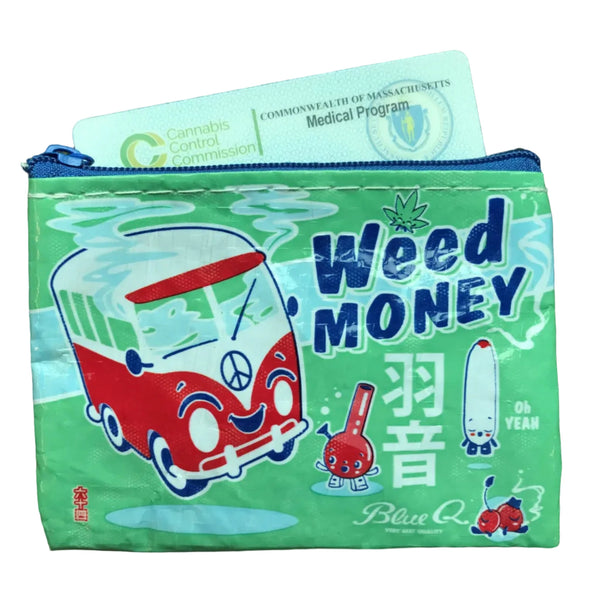 A green zippered pouch featuring a cartoon red and white van, a bong, and the text 'Weed MONEY' in blue, with a blue zipper pull. A cannabis compliance card is partially visible inside the pouch, which is placed on a textured olive green fabric background.