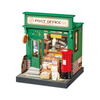Model of a post office with a red mailbox and a cat on a white background