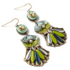 Colorful earrings with green, blue, and gold elements on a white background