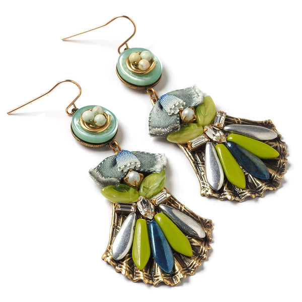 Colorful earrings with green, blue, and gold elements on a white background