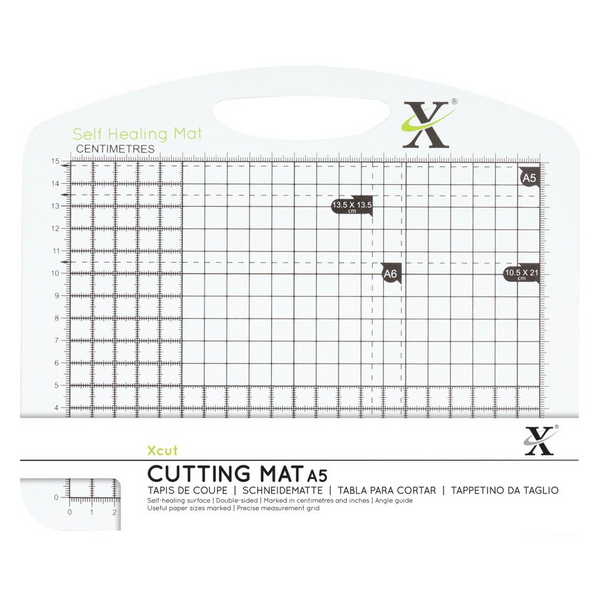 Cutting mat with grid and measurement markings on a white background