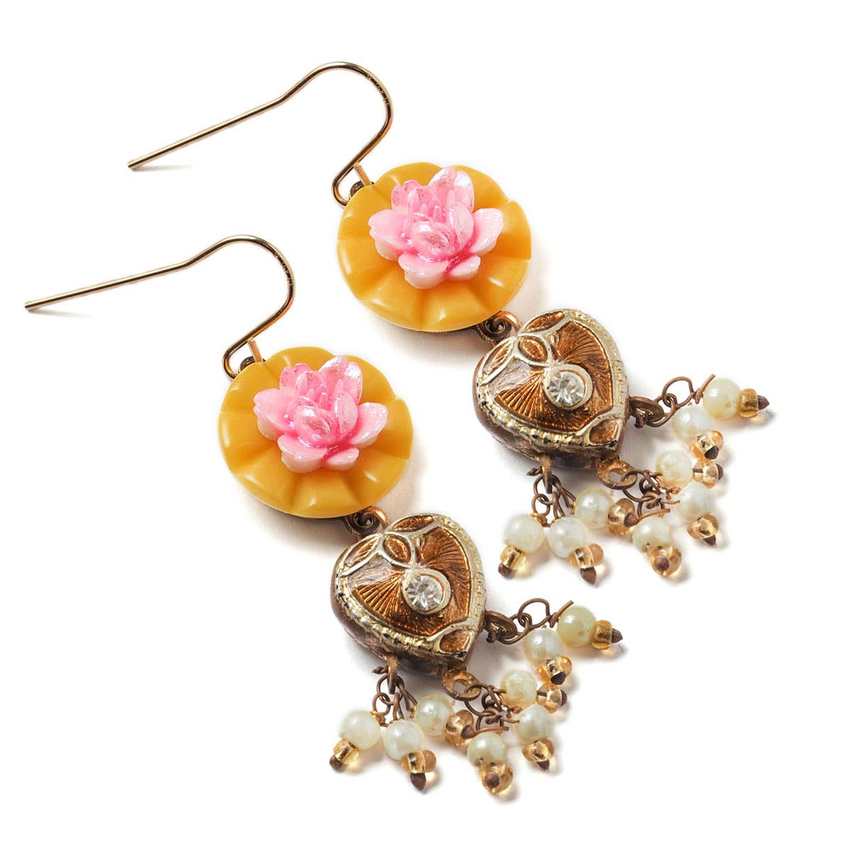 Decorative earrings with floral and heart designs on a white background