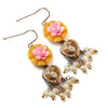 Decorative earrings with floral and heart designs on a white background