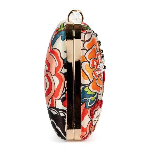 Colorful floral-patterned clutch bag on a white background