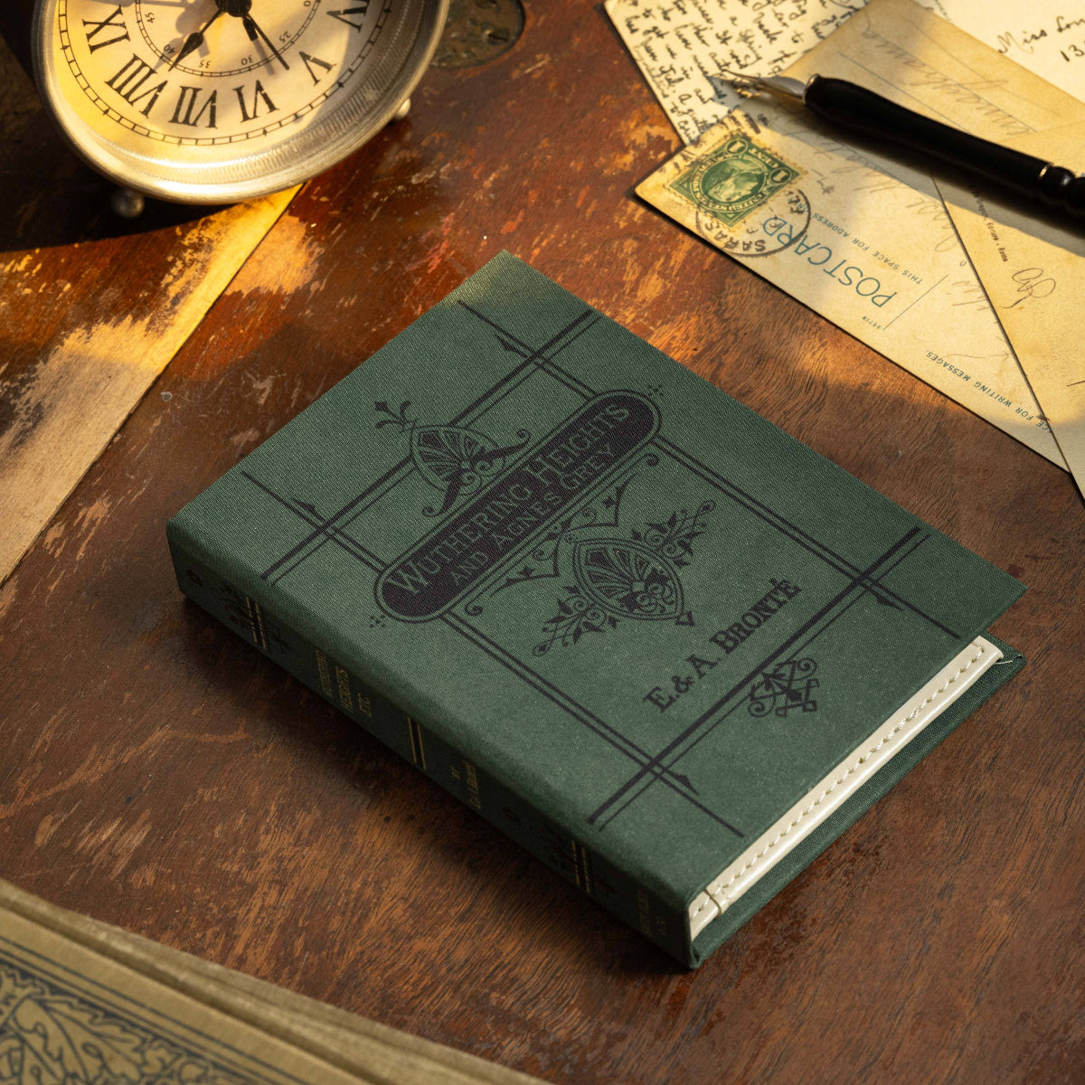 A book-style passport/notebook wallet with a green cover, featuring an old-fashioned design and the title 'Wuthering Heights' by Emily Brontë on the cover.