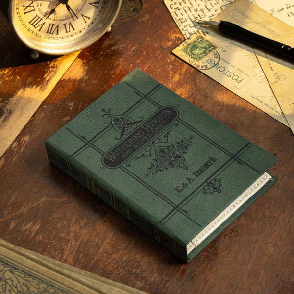A book-style passport/notebook wallet with a green cover, featuring an old-fashioned design and the title 'Wuthering Heights' by Emily Brontë on the cover.