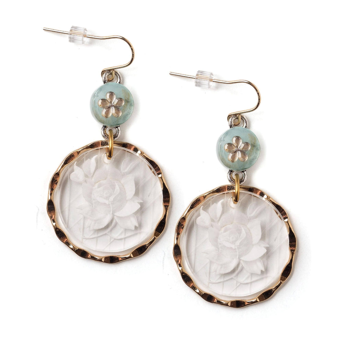 Pair of earrings with floral designs on a white background
