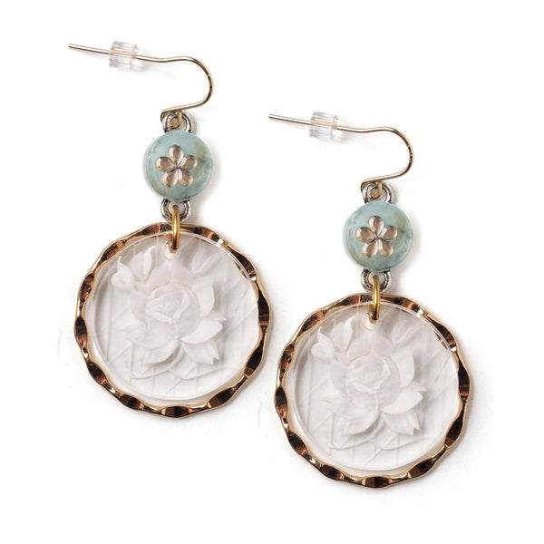 Pair of earrings with floral designs on a white background