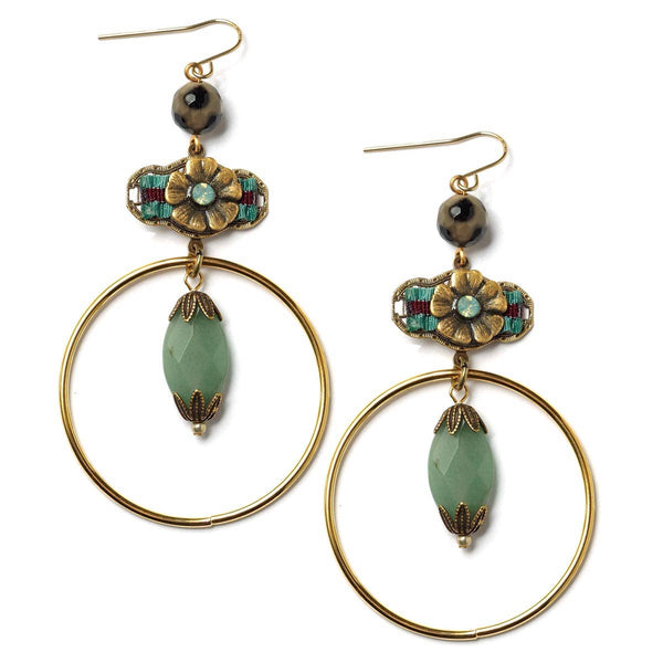 Pair of gold hoop earrings with green beads and floral designs on a white background