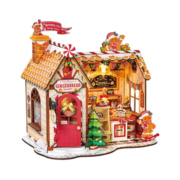 Gingerbread bakery model with a red door and festive decorations on a white background