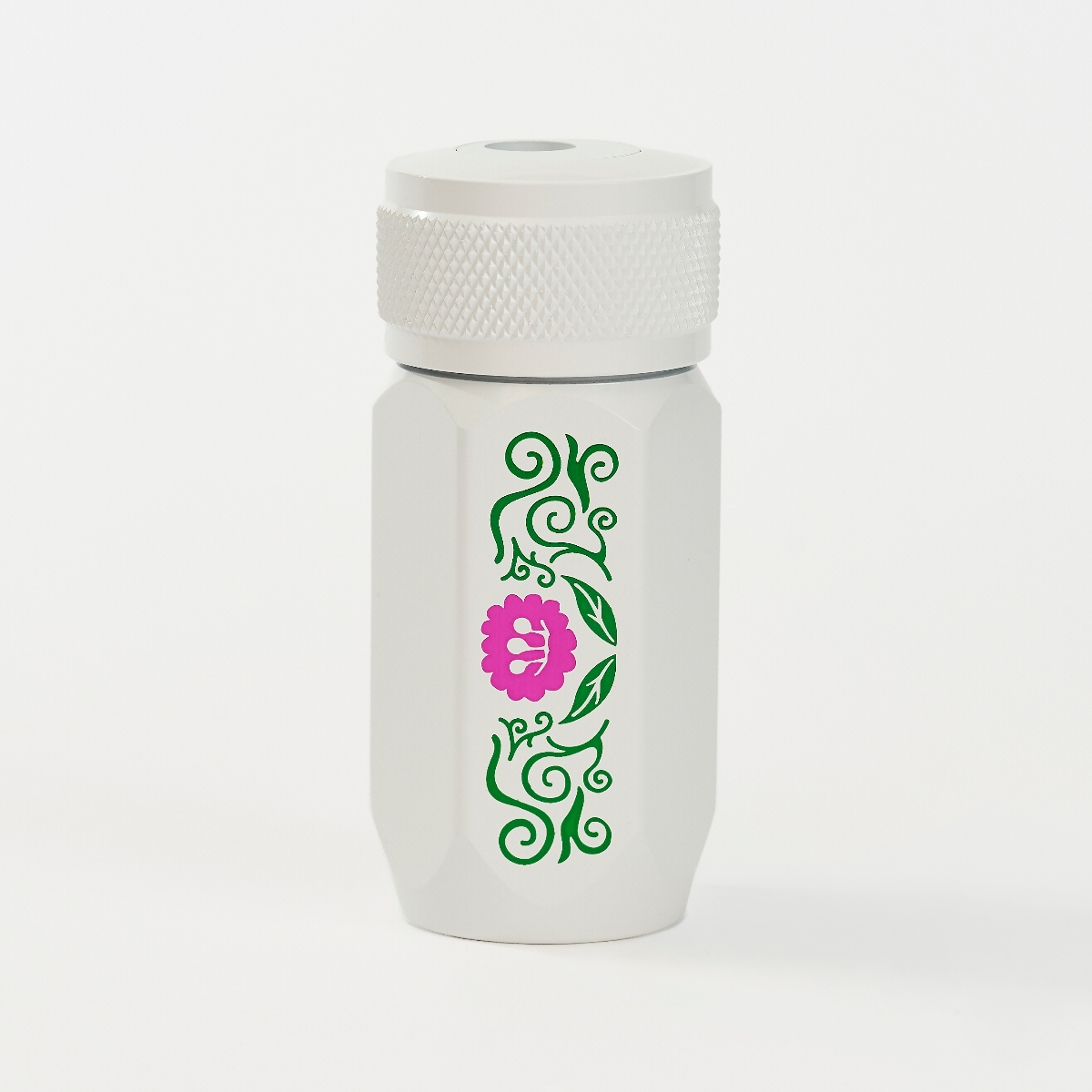 A white insulated travel tumbler with a matching white lid, featuring a vertical green vine pattern and a pink flower graphic on the front.