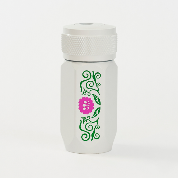 A white insulated travel tumbler with a matching white lid, featuring a vertical green vine pattern and a pink flower graphic on the front.