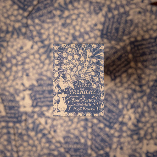Book cover of 'Pride and Prejudice' by Jane Austen on a patterned fabric background