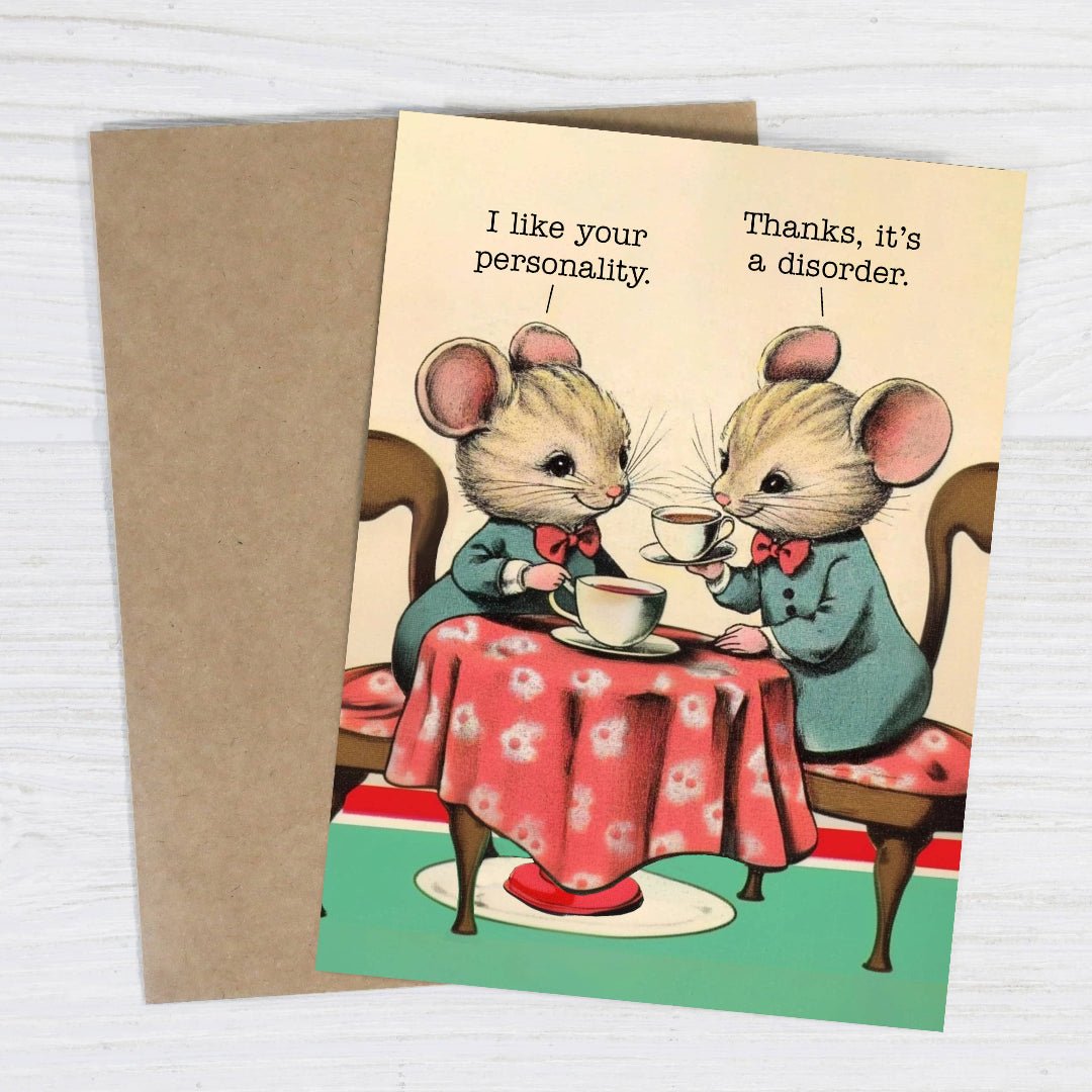 Card with two mice at a table, one saying 'I like your personality.' and the other responding 'Thanks, it's a disorder.'