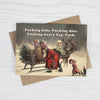 Card with a vintage-style illustration of Santa Claus and reindeer, with profane text on a white background.